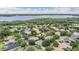 Panoramic aerial view of the neighborhood, highlighting the lake, greenery, and community at 3727 Janus Way, Palm Harbor, FL 34685