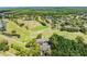 Expansive aerial view showcasing Lansbrook Golf Club's beautiful course, scenic ponds, and surrounding lush greenery at 3727 Janus Way, Palm Harbor, FL 34685