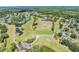 Expansive aerial view of a well-manicured golf course with serene ponds and lush surroundings at 3727 Janus Way, Palm Harbor, FL 34685