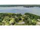 Expansive aerial view of a lakefront community surrounded by lush greenery and natural beauty at 3727 Janus Way, Palm Harbor, FL 34685