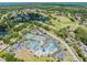Panoramic aerial view highlighting the golf course, pool, tennis courts, and community amenities at 3727 Janus Way, Palm Harbor, FL 34685
