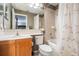 Bathroom with a single sink vanity, tub, and shower with neutral tones at 3727 Janus Way, Palm Harbor, FL 34685