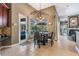 A bright dining area features a stylish table with seating, a view to the pool, and natural light at 3727 Janus Way, Palm Harbor, FL 34685