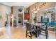 A cozy dining area features a stylish table with seating, chandelier, and natural light at 3727 Janus Way, Palm Harbor, FL 34685