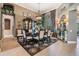 Elegant dining room featuring a large dining table, china cabinet, and natural light from a large window at 3727 Janus Way, Palm Harbor, FL 34685