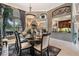 Charming dining room with a formal table set, a large window, and seamless flow to the outdoor living space at 3727 Janus Way, Palm Harbor, FL 34685