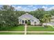 Charming single-story home with a well-manicured lawn, lush landscaping, and a welcoming entryway at 3727 Janus Way, Palm Harbor, FL 34685