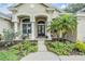 Charming front entry with a well-manicured garden and a beautiful front door and sidelights at 3727 Janus Way, Palm Harbor, FL 34685