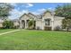 Well-maintained home featuring lush green lawn, manicured landscaping, and neutral exterior at 3727 Janus Way, Palm Harbor, FL 34685