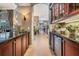 Hallway featuring dark wood cabinets and beverage cooler leading to other areas of the home at 3727 Janus Way, Palm Harbor, FL 34685