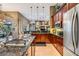 A stylish kitchen is equipped with stainless steel appliances, granite countertops, and dark wood cabinetry at 3727 Janus Way, Palm Harbor, FL 34685