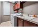 Laundry room with a washer, dryer, utility sink, cabinets, and tile floor at 3727 Janus Way, Palm Harbor, FL 34685