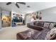 Comfortable living room features a leather sofa, entertainment center, and guitars at 3727 Janus Way, Palm Harbor, FL 34685