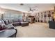 Spacious living room has a large leather sofa and guitars displayed on the wall at 3727 Janus Way, Palm Harbor, FL 34685