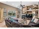 A comfortable living room provides ample seating, a fireplace, and a view of the pool at 3727 Janus Way, Palm Harbor, FL 34685