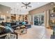 A comfortable living room offers ample seating, an open floorplan, and a view of the dining area at 3727 Janus Way, Palm Harbor, FL 34685