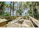 Outdoor picnic area on a wooden deck with a picnic table, surrounded by lush greenery at 3727 Janus Way, Palm Harbor, FL 34685