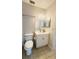 Clean bathroom featuring a toilet, vanity, and a large mirror with bright lights at 3829 S Lake Dr # 215, Tampa, FL 33614