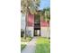 A condo exterior with palm trees and a lush green lawn at 3829 S Lake Dr # 215, Tampa, FL 33614