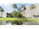 Beautiful pond view from this complex, with green lawn and stately palm trees at 3829 S Lake Dr # 215, Tampa, FL 33614
