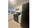 Bright kitchen with white cabinets, black appliances, tile floors, and lots of natural light at 3829 S Lake Dr # 215, Tampa, FL 33614