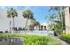 A serene view of the community pool, framed by lush greenery and tall palm trees, promising a relaxing retreat at 3829 S Lake Dr # 215, Tampa, FL 33614
