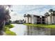 Beautiful waterfront view of a condo building from across a calm waterway at 3829 S Lake Dr # 215, Tampa, FL 33614