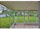 The screened-in porch overlooks a large, grassy backyard featuring mature trees and a fire pit at 404 12Th Sw St, Ruskin, FL 33570