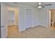 Bright bedroom featuring tile floors, ceiling fan, and ensuite bathroom for added convenience and comfort at 404 12Th Sw St, Ruskin, FL 33570