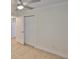 Neutral bedroom with tile floors, ceiling fan, and closet with white doors at 404 12Th Sw St, Ruskin, FL 33570