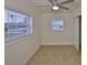 Well-lit bedroom featuring two windows, tile flooring, and ample natural light for a comfortable and inviting space at 404 12Th Sw St, Ruskin, FL 33570