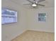 Sunlit bedroom with two windows and tile flooring, creating a bright and inviting space for relaxation at 404 12Th Sw St, Ruskin, FL 33570