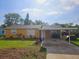 Charming single-story home features a covered parking area and a well-maintained front lawn at 404 12Th Sw St, Ruskin, FL 33570