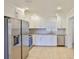 Bright kitchen with stainless steel appliances, granite countertops and tile floors at 404 12Th Sw St, Ruskin, FL 33570