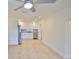Open living space with a view of the modern kitchen featuring stainless steel appliances and granite countertops at 404 12Th Sw St, Ruskin, FL 33570