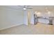 Bright, open-concept space with stainless steel kitchen appliances, tile flooring, and modern ceiling fan at 404 12Th Sw St, Ruskin, FL 33570