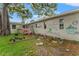 View of backyard with graffiti on the exterior wall and a small pink deck at 4600 Chancellor Ne St, St Petersburg, FL 33703