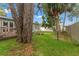 Large backyard featuring a deck and lush green grass with mature trees at 4600 Chancellor Ne St, St Petersburg, FL 33703