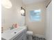Well-lit bathroom features a vanity with storage, globe lighting, and black-and-white patterned tile floor at 4600 Chancellor Ne St, St Petersburg, FL 33703