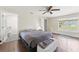 Well-lit bedroom featuring a ceiling fan, dark wood-look floors, and en suite bath access at 4600 Chancellor Ne St, St Petersburg, FL 33703