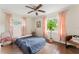 Cozy bedroom featuring a ceiling fan, windows with curtains and a potted plant at 4600 Chancellor Ne St, St Petersburg, FL 33703