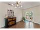 Bright dining area with wood-look tile floors and stylish modern lighting fixture at 4600 Chancellor Ne St, St Petersburg, FL 33703