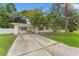 Charming single-story home with a long driveway and mature trees in the front yard at 4600 Chancellor Ne St, St Petersburg, FL 33703