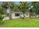Single-story home with a well-maintained lawn, established trees, and a clean, inviting front facade at 4600 Chancellor Ne St, St Petersburg, FL 33703