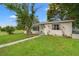 Charming single-story home featuring a well-manicured lawn, mature trees, and a welcoming front entrance at 4600 Chancellor Ne St, St Petersburg, FL 33703