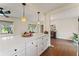 Bright open kitchen with a large center island, stylish pendant lights, and wood-look tile flooring at 4600 Chancellor Ne St, St Petersburg, FL 33703