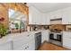 Modern kitchen features a farmhouse sink, stainless steel appliances, granite countertops, and stylish brick backsplash at 4600 Chancellor Ne St, St Petersburg, FL 33703
