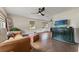 Inviting living room with hardwood floors, ceiling fan, and natural light from the two windows at 4600 Chancellor Ne St, St Petersburg, FL 33703