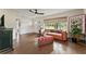 A cozy living area with tile floors, a comfortable leather sofa, and bright natural light from a large window at 4600 Chancellor Ne St, St Petersburg, FL 33703