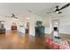 An open-concept living room with tile floors and contemporary ceiling fans offers a comfortable and inviting space at 4600 Chancellor Ne St, St Petersburg, FL 33703